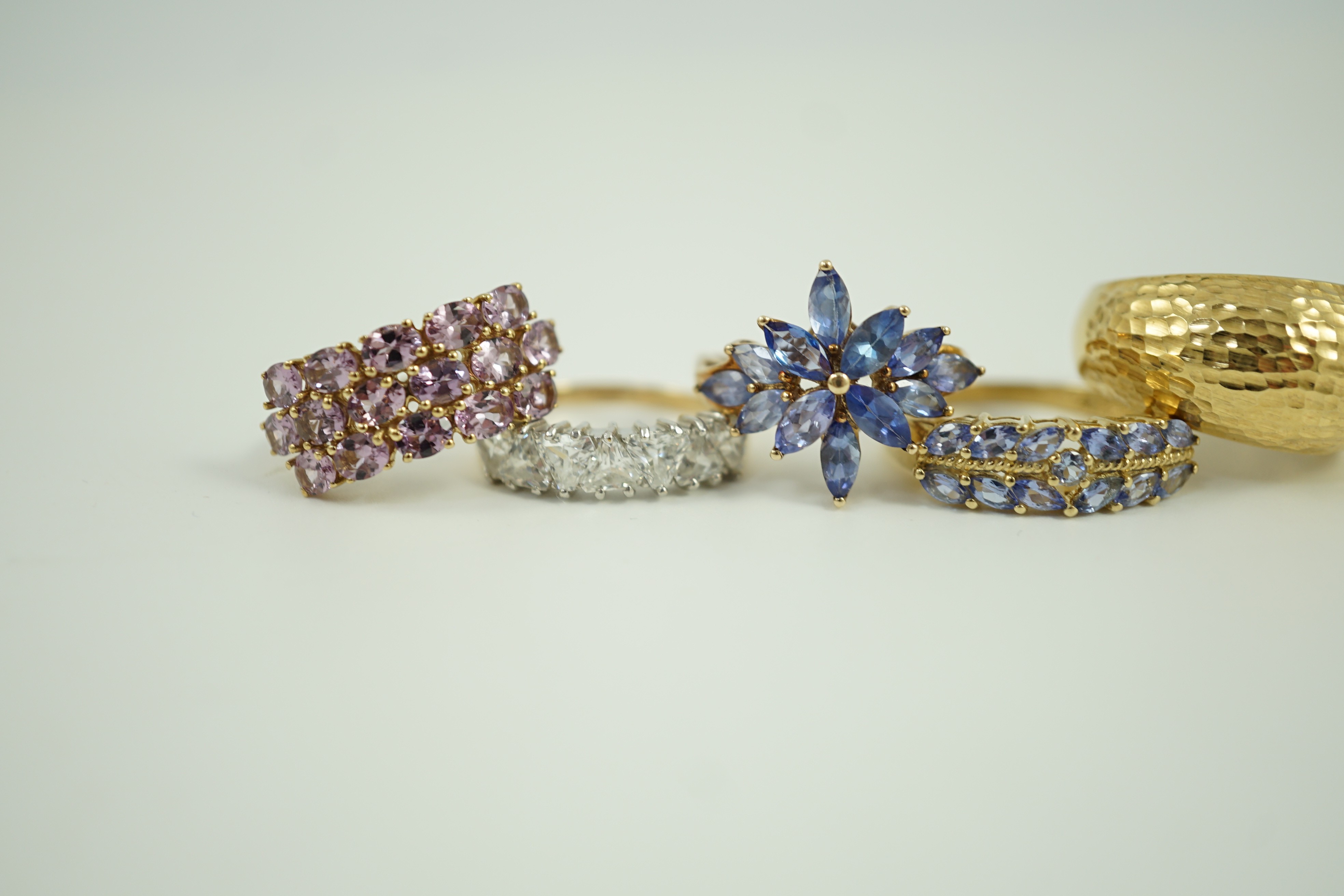 Four assorted modern 9ct gold and gem set rings and an Italian 375 ring, gross weight 14.4 grams.